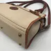 Dooney & Bourke All Weather Leather bone and British tan pebbled leather buckle crossbody satchel